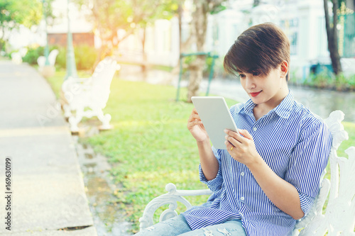 Beautiful Short Hair Woman Sitting On White Chair Under The