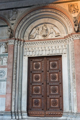 Wall Mural - Details of the Romanesque Facade and bell tower of St. Martin Cathedral in Lucca, Tuscany. 