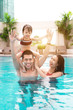 © makistock - Happy family in swimming pool. Summer holidays and vacation concept