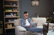 © Svyatoslav Lypynskyy - Freelancer hipster guy working with laptop on sofa. Home office, young man typing on laptop sitting on couch.