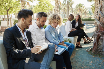 Group of businessmen working outside together