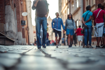 Blurred people walking and standing on the street