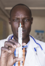 Doctor Using Needle And Syringe. Kenya, Africa