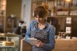 © Wavebreak Media - Waitress using digital tablet