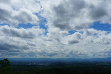 Wall Mural - blue cloudy sky over the city. view from the top of mountain