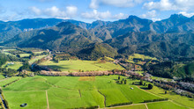 Aerial View On A Farmland At The Foot Of Mountain Ridge. Coromandel, New Zealand