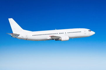 Passenger white airplane on the side view, flies on a flight level sky