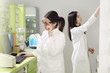 © phoenix021 - Two young adult woman working in pharmacy