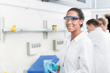 Female Lab Technician With Safety Goggles In Laboratory