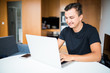 © F8  \ Suport Ukraine - Self employed man with smile working from home on laptop
