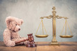 Bronze law scales and Teddy Bear with wooden gavel on table. Symbols of justice. Vintage old style filtered photo