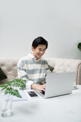 Wall Mural - Asian young business man working with laptop atthe city cafe.