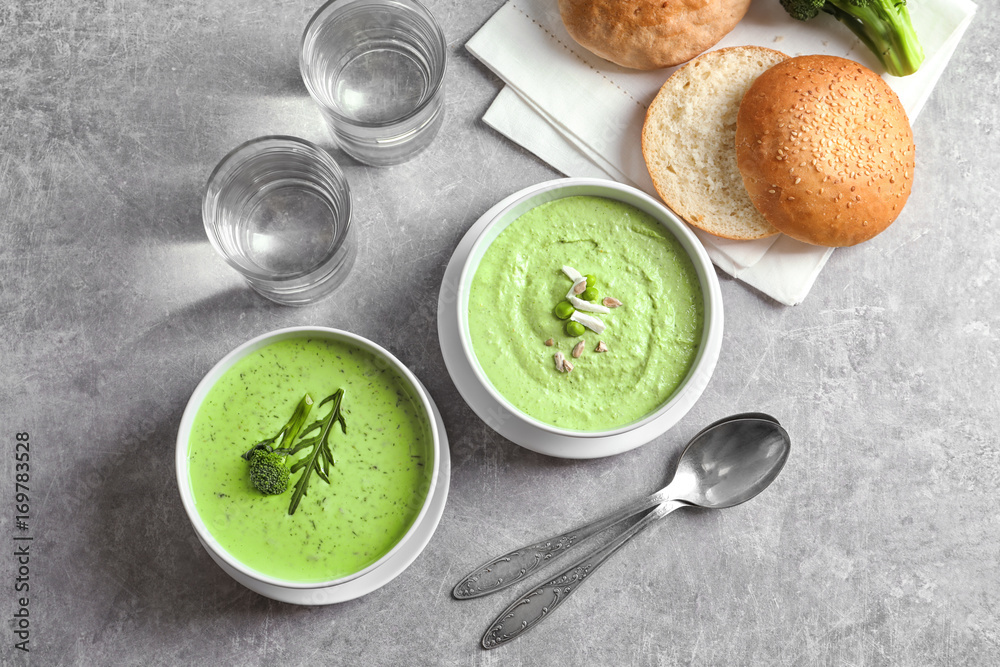 Composition with delicious broccoli soup on light background