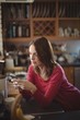 © Wavebreak Media - Woman using mobile phone in kitchen