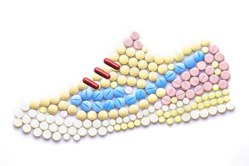 Wall Mural - Running hard / Creative medicine and healthcare concept made of drugs and pills, in the shape of running shoes.