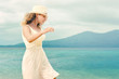 © soft_light - Cheerful woman wearing white dress on a beach