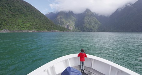 Wall Mural - Cruise ship in New Zealand Milford Sound Fiordland National Park. Tourist enjoying boat tour travel and amazing view of fjord in most famous travel destination in New Zealand.