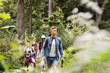 © Halfpoint - Teenagers with backpacks hiking in forest. Summer vacation.