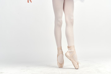Wall Mural - Ballerina's feet on a white background