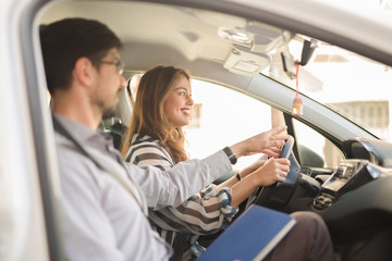 Young woman on a driving test with her instructor