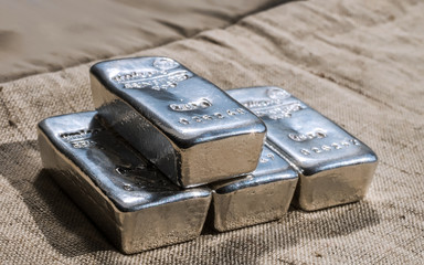cast silver bars against the background of the texture of. selective focus.