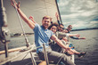 canvas print picture - Happy friends resting on a yacht