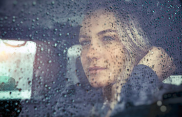 Beautiful sad woman in the car