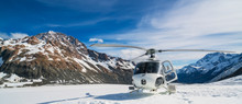 Helicopter Landing On A Snow Mountain