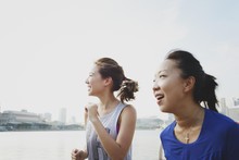 Two Happy Women Running At Marina Bay Sands