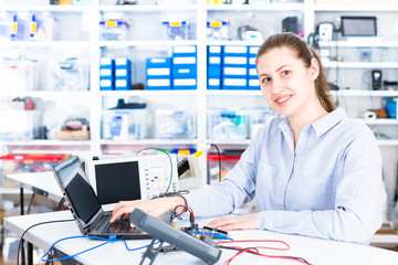 Poster - Young woman in electronics repair service center