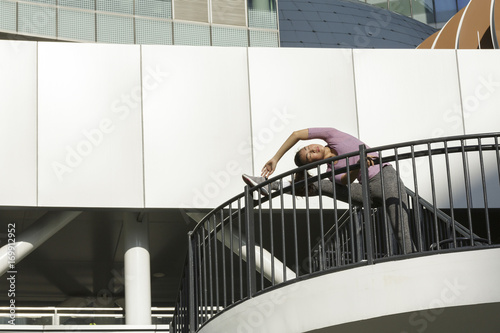 Asian Woman Stretching on a handrail Asian Woman Stretching on a handrail - Buy this stock photo and ...