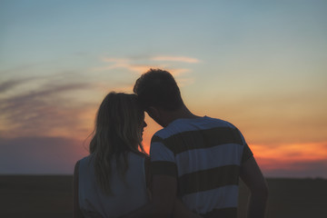 Young couple enjoying outdoors in the field.