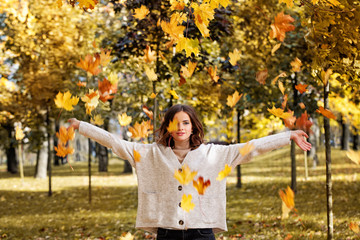 Wall Mural - Autumn Woman Fashion Model with Fall Leaves in the Autumn Park Outdoors