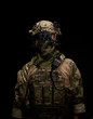 Soldier in military uniform with night vision goggles on background of dark wall 16