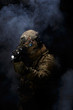 Soldier in military uniform with assault rifle aiming with laser at target in smoke on background of dark wall 14