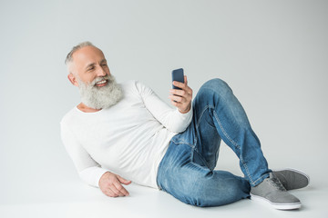 Wall Mural - senior man with smartphone