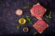 © timolina - Fresh raw homemade minced beef steak burger with spices on black background