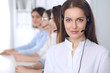 © rogerphoto - Call center operator.Young beautiful business woman in headset