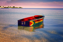 Traditional Jamaican Fishing Boat Floating Out From The Beach On Bloody Bay, Jamaica.
