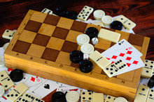 Various Board Games Chess Board, Playing Cards, Dominoes. Hobby. Metaphor For Games And Gambling.