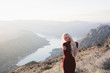 © Jovana Rikalo/Stocksy - Portrait of a young woman standing on the hill