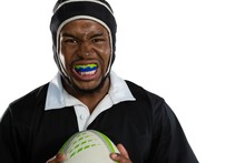Portrait Of Male Rugby Player Wearing Mouthguard White Holding