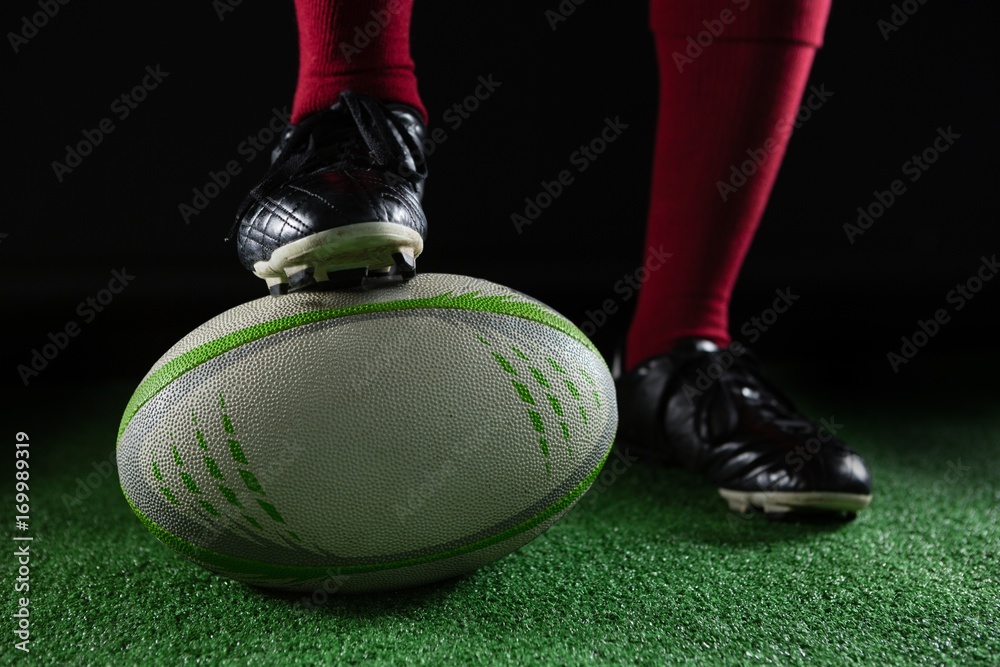 Low section of person stepping on rugby ball Stock Photo | Adobe Stock