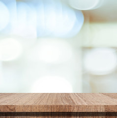 Empty wooden table over blurred abstract bokeh light background, product display montage, template