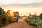 Fototapeta  - Red ground and dust on the rural road in Cambodia