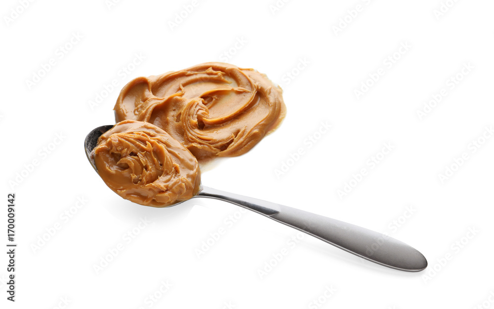 Creamy peanut butter in spoon on white background