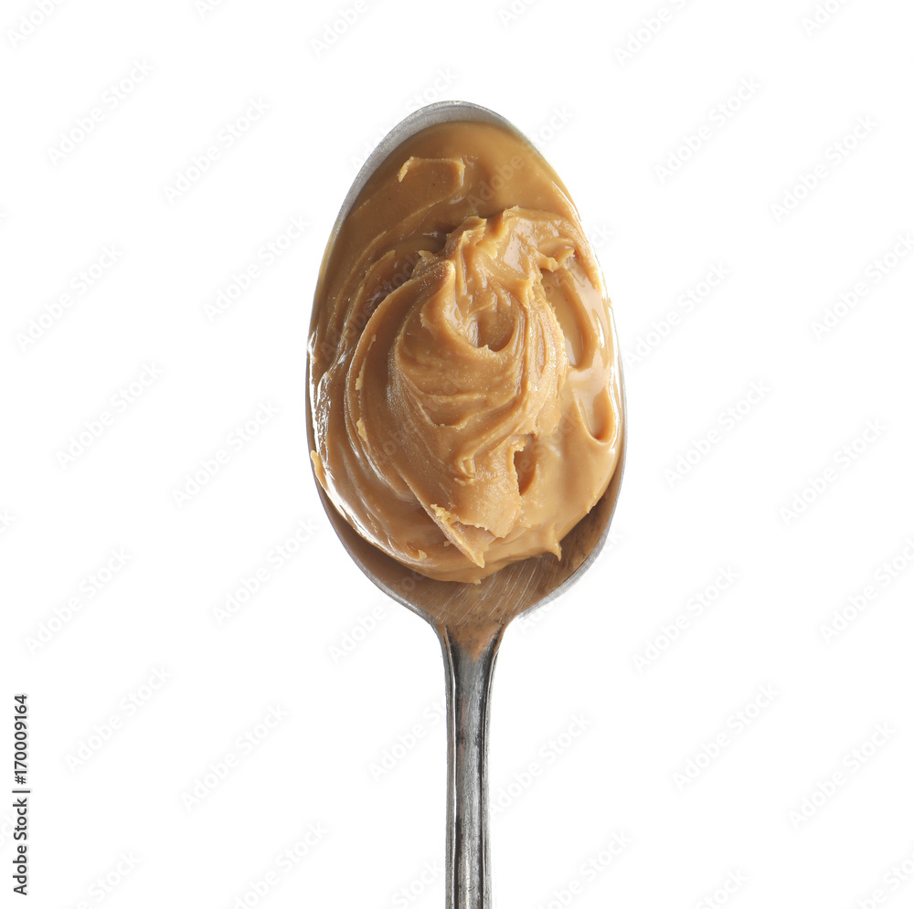 Creamy peanut butter in spoon on white background