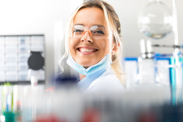 Happy young attractive smiling woman scientist in the laboratory