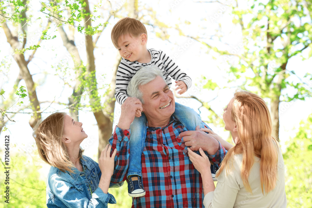 Cute happy children with grandparents in spring park