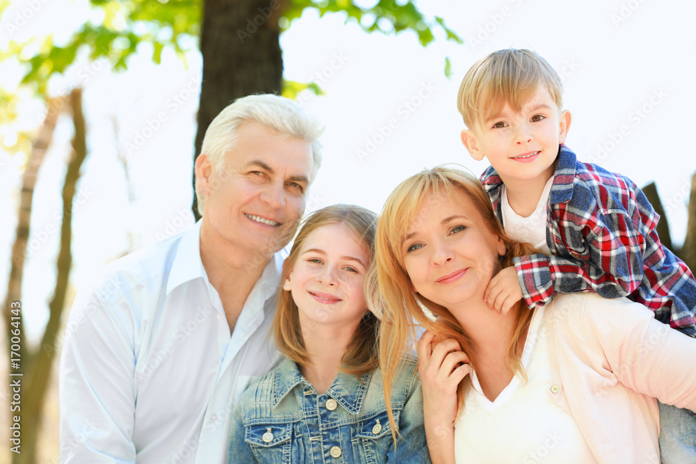 Cute happy children with grandparents in spring park
